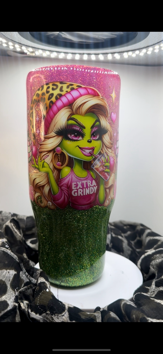 Glitter tumbler with a glam green cartoon character, "EXTRA GRINDY" pink shirt, pink-to-green glitter fade, and bold leopard accents